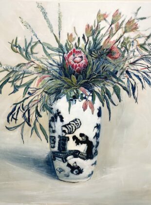 Native flowers in blue and white vase